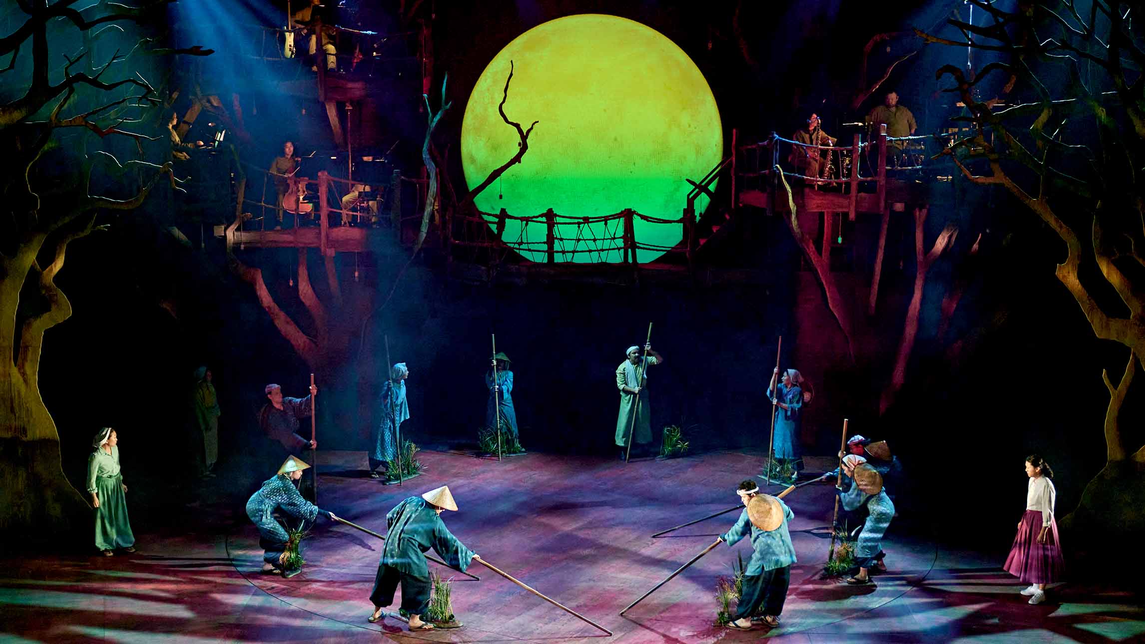 A wide shot of actors and the set of My Neighbour Totoro theatre production at the Gillian Lynne Theatre, London