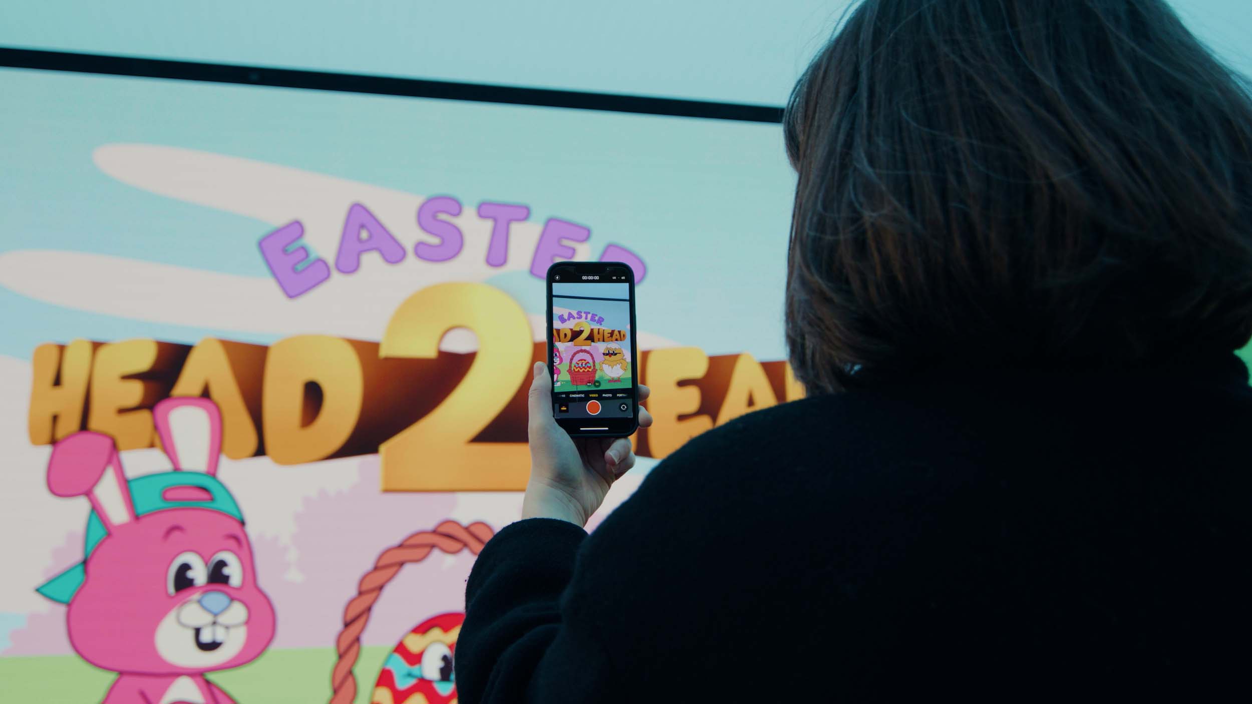 Woman taking a video of an Easter display