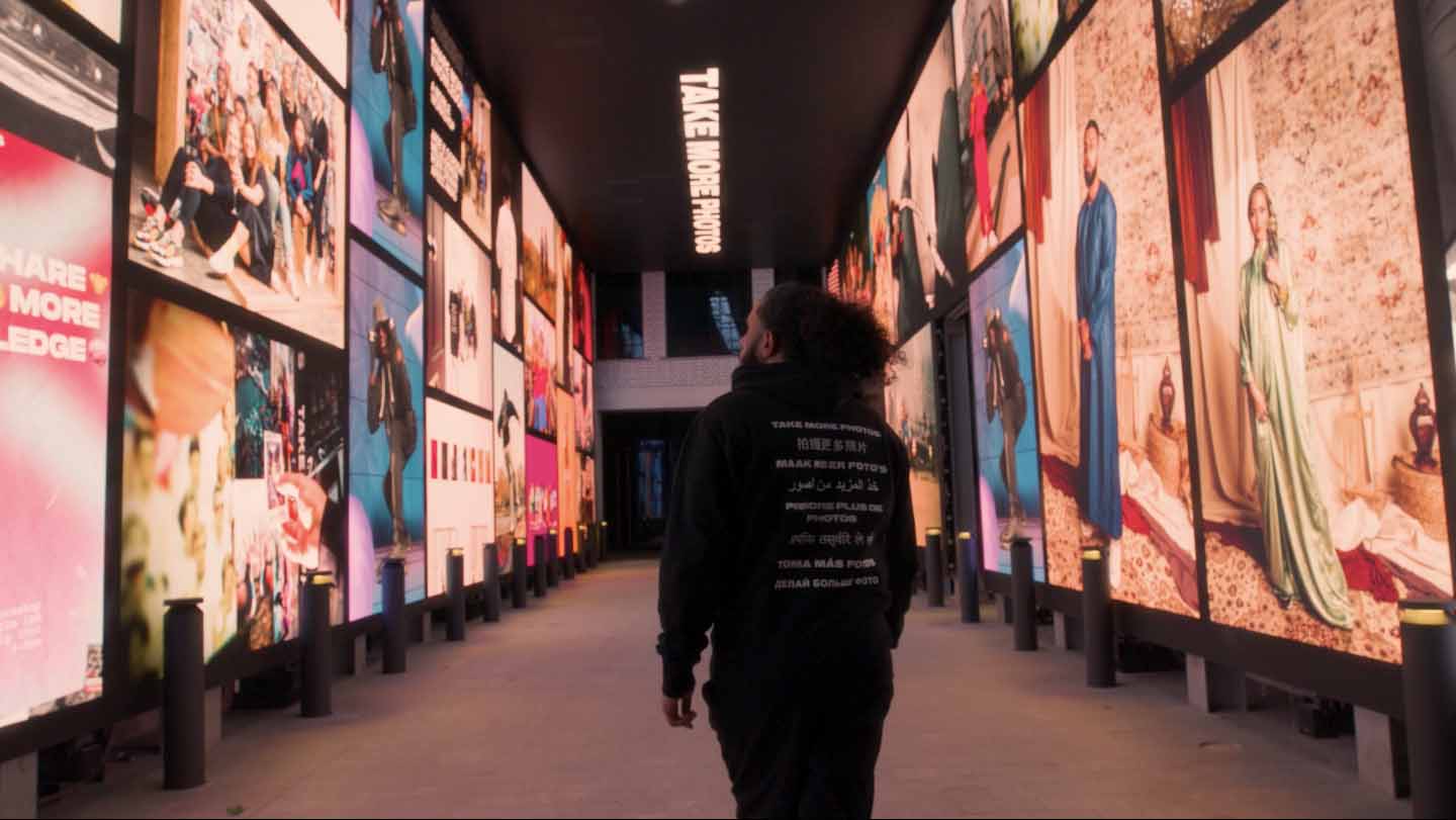 Visitor walking down The Now Arcade looking at the displays