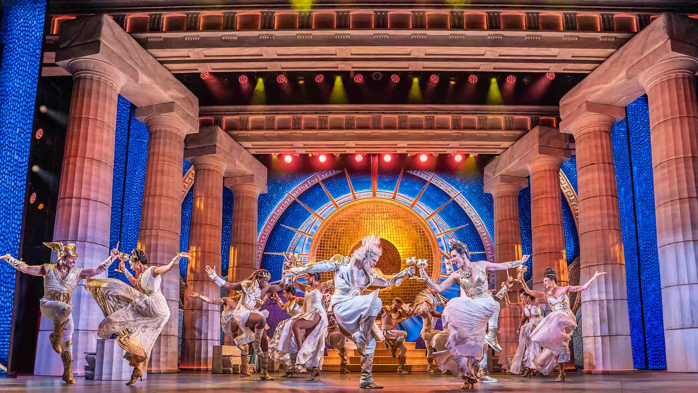A chorus of actors dancing on stage in Disney's Hercules