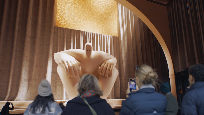 Visitors to Outernet watch a giant in the FLOW exhibit