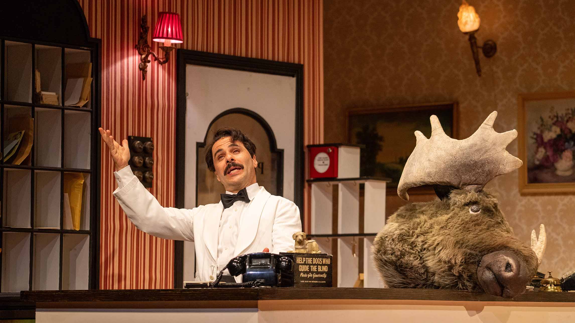 Manuel and a moose head in Fawlty Towers