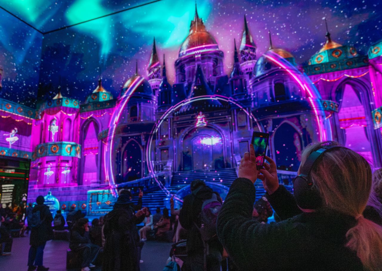 Woman interacts with the Ice Palace at Outernet