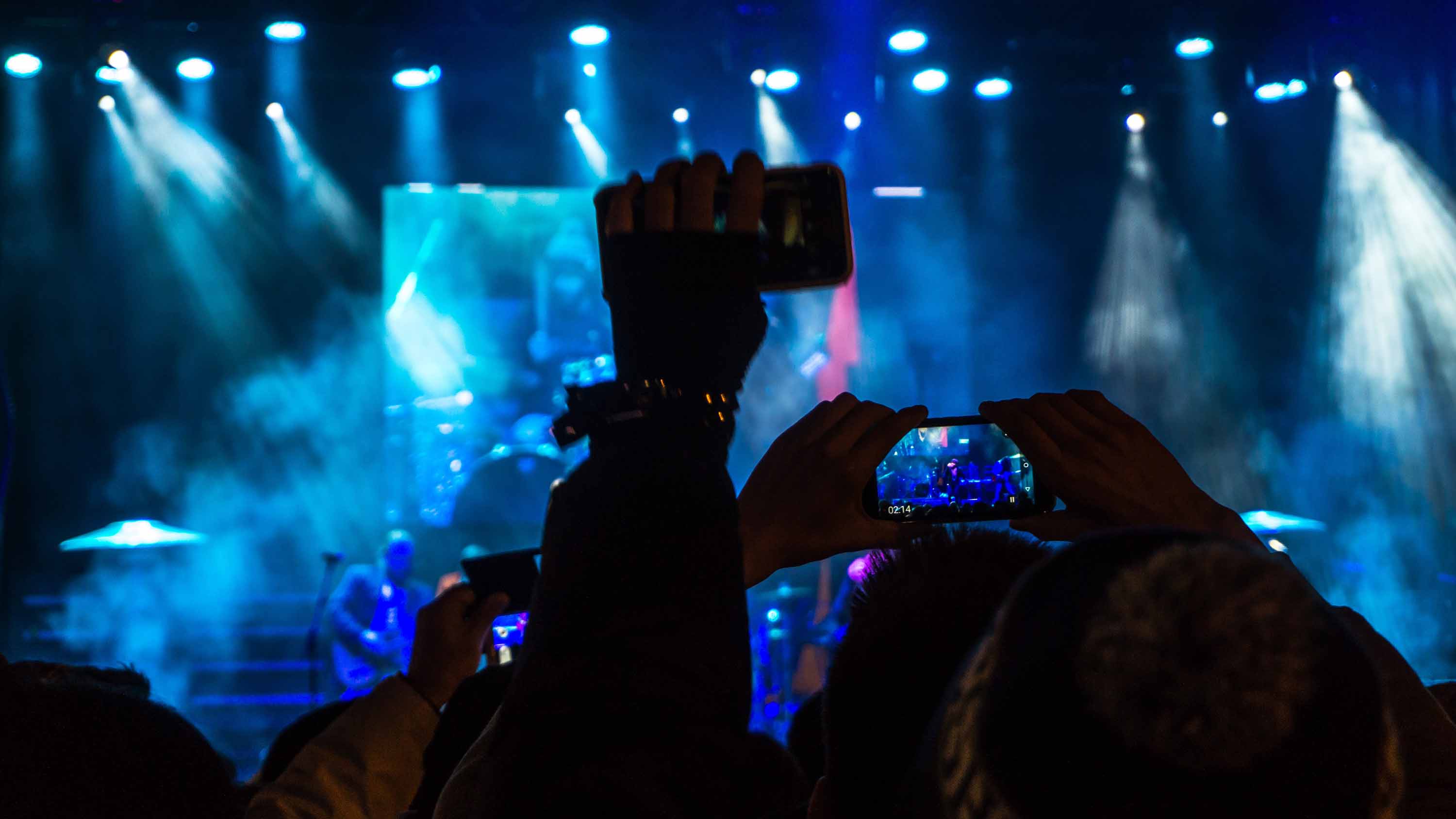 Crowd filming the live band on their smart phones