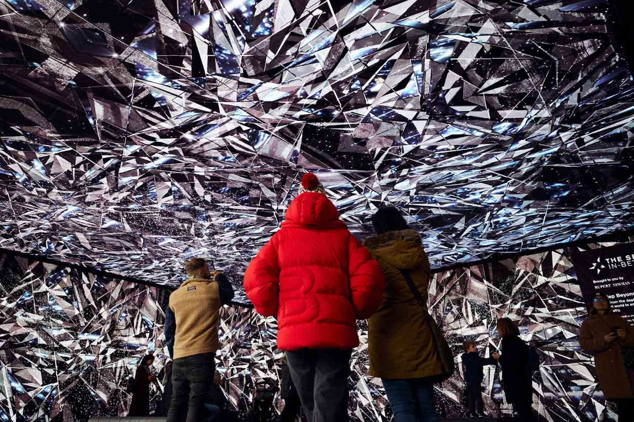 People looking at the Spaces In-Between immersive experience